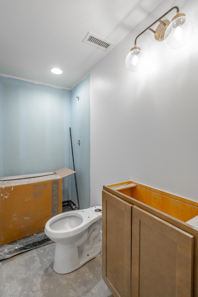 bathroom featuring concrete floors and toilet