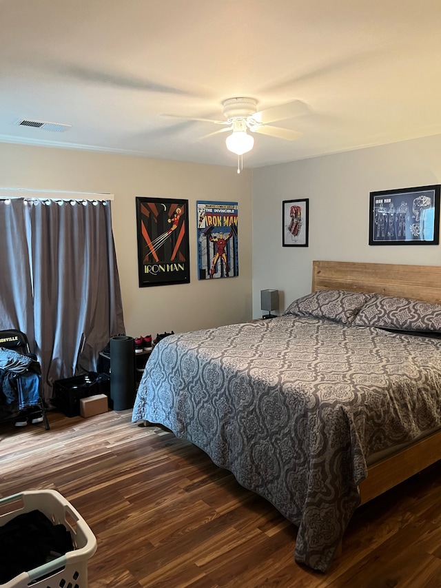 bedroom featuring ceiling fan and dark wood-type flooring