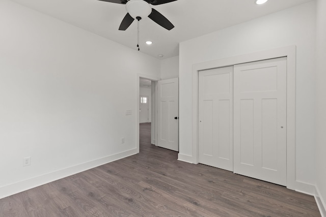 unfurnished bedroom featuring ceiling fan, a closet, and dark hardwood / wood-style flooring