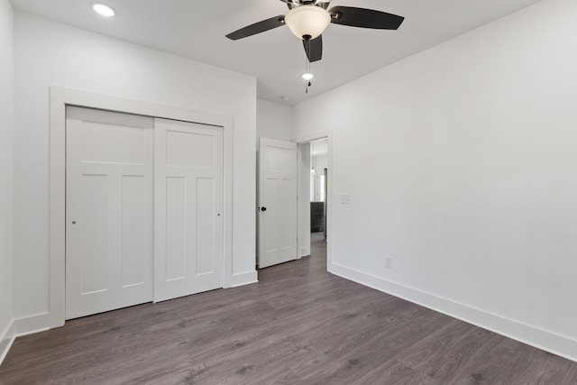 unfurnished bedroom featuring a closet, hardwood / wood-style flooring, and ceiling fan