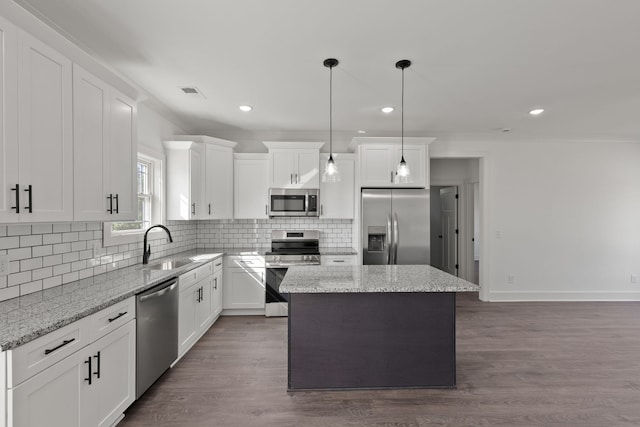 kitchen featuring white cabinets, appliances with stainless steel finishes, dark hardwood / wood-style floors, and a kitchen island