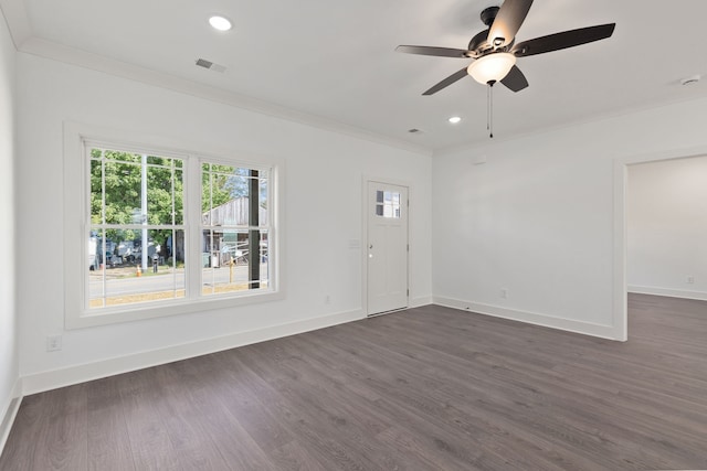 spare room with ornamental molding, dark hardwood / wood-style floors, and ceiling fan