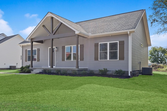 view of front of house featuring cooling unit and a front lawn