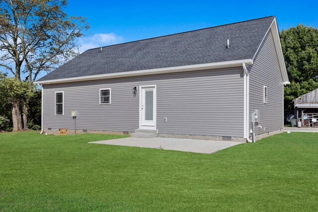 rear view of property featuring a lawn