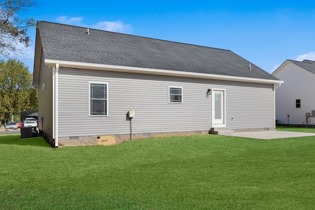 rear view of property featuring cooling unit, a yard, and a patio area