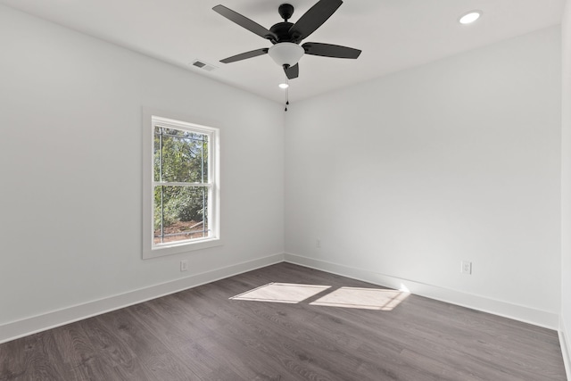 spare room with ceiling fan and dark hardwood / wood-style floors