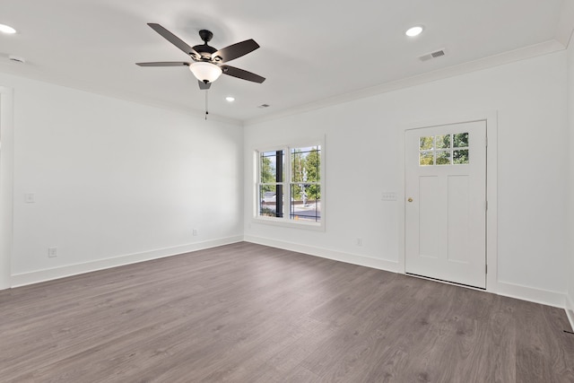 empty room featuring ceiling fan, dark wood-type flooring, and a healthy amount of sunlight