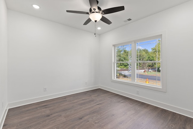 spare room featuring ceiling fan and dark wood-type flooring