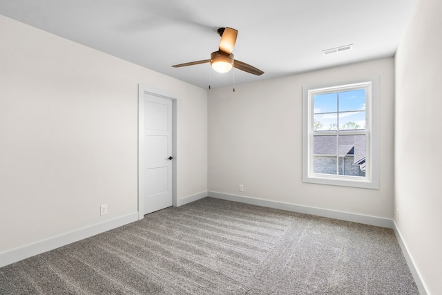 spare room with ceiling fan and carpet