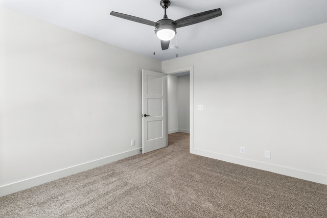 carpeted empty room featuring ceiling fan