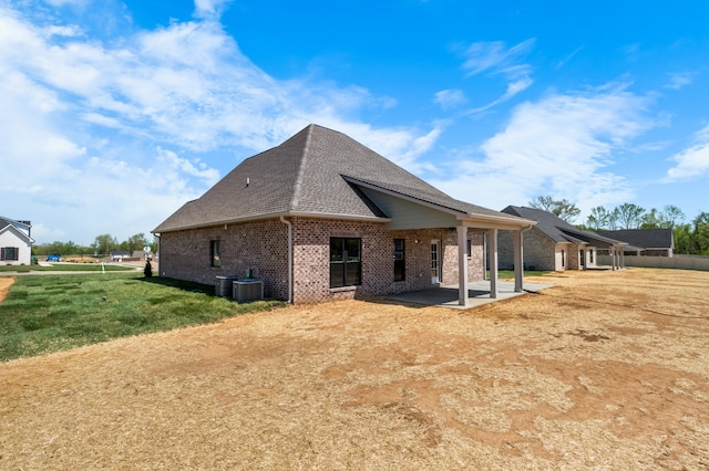 view of side of property with a yard and a patio area