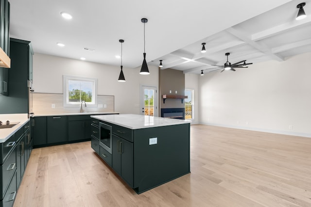 kitchen with beam ceiling, ceiling fan, coffered ceiling, decorative backsplash, and a kitchen island