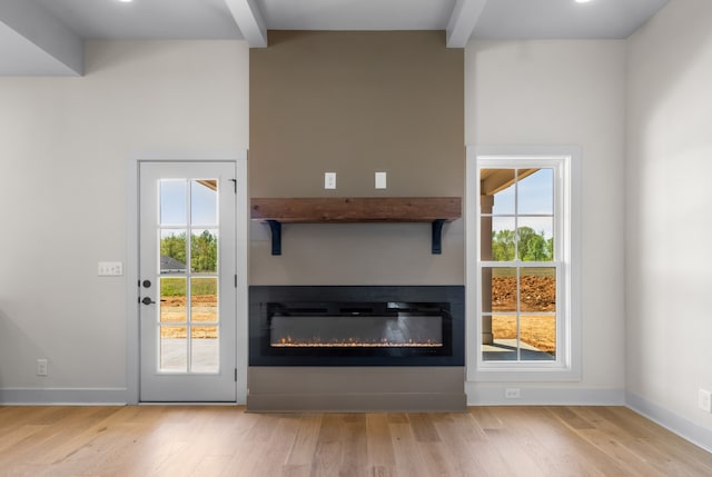 entryway featuring beam ceiling and light wood-type flooring