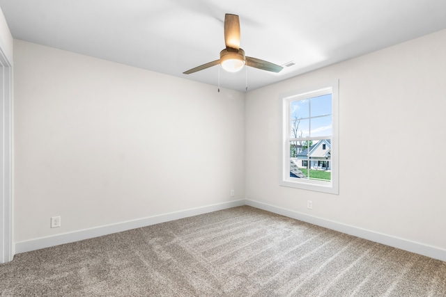 carpeted spare room with ceiling fan