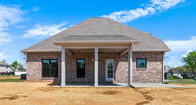 back of property with a patio