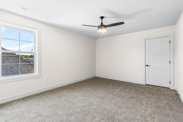 carpeted spare room with ceiling fan