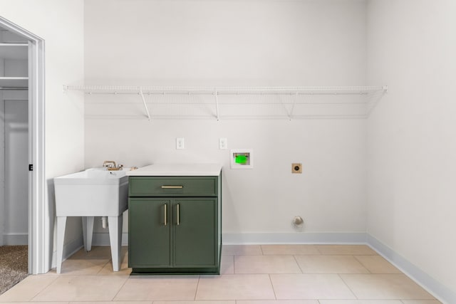 laundry room featuring washer hookup, electric dryer hookup, cabinets, and light tile patterned floors