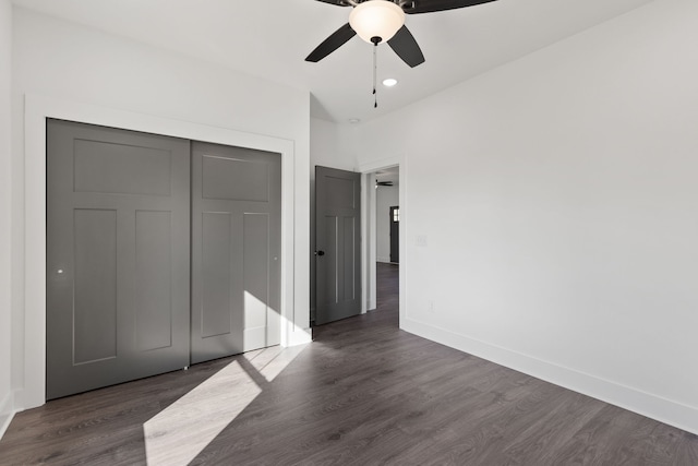 unfurnished bedroom featuring ceiling fan, a closet, and dark hardwood / wood-style flooring