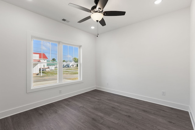 empty room featuring ceiling fan and dark hardwood / wood-style floors