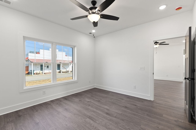 spare room with ceiling fan and dark hardwood / wood-style floors