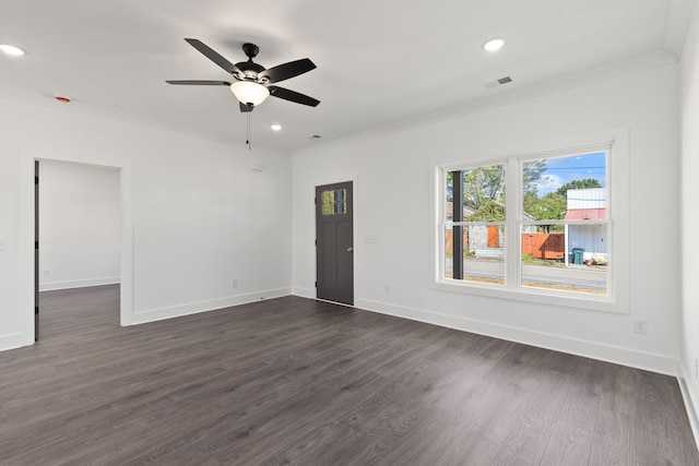 spare room with crown molding, dark wood-type flooring, and ceiling fan