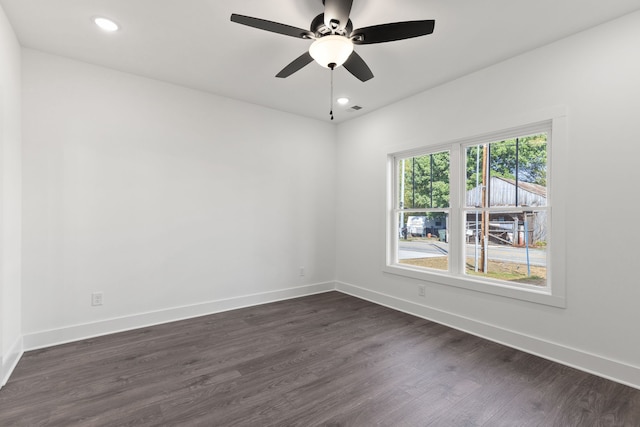 empty room with ceiling fan and dark hardwood / wood-style floors