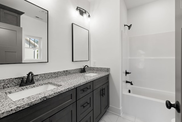 bathroom with bathtub / shower combination, tile patterned flooring, and vanity