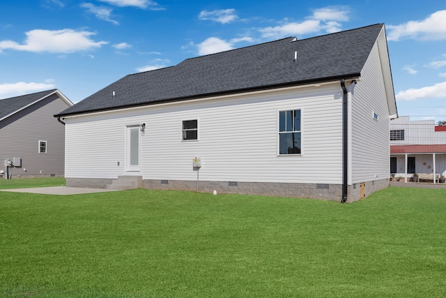 rear view of property with a yard and a patio