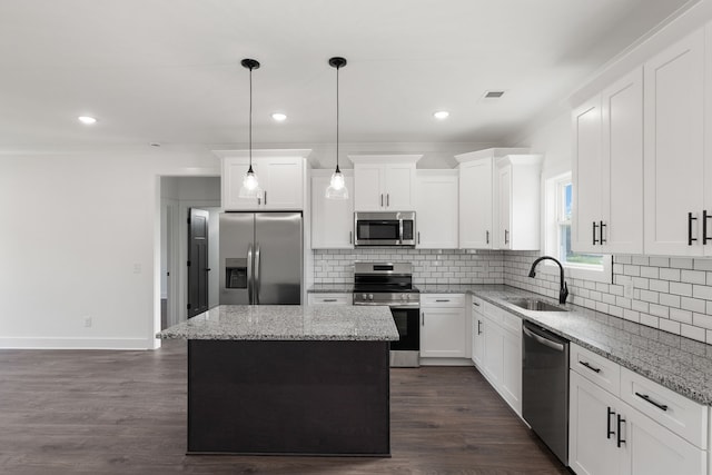 kitchen featuring dark hardwood / wood-style flooring, stainless steel appliances, a kitchen island, and sink