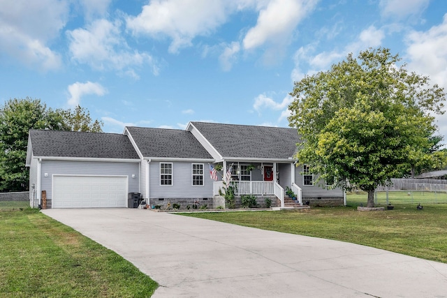 ranch-style house featuring covered porch, a front yard, and a garage