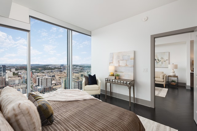 bedroom featuring multiple windows, dark hardwood / wood-style floors, and expansive windows