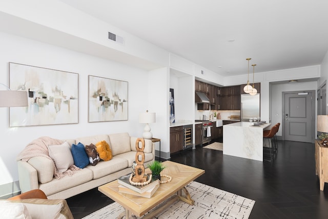 living room featuring wine cooler and dark parquet flooring