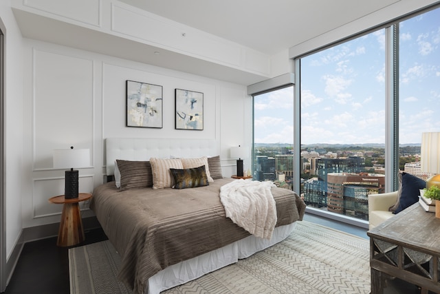 bedroom featuring wood-type flooring and expansive windows