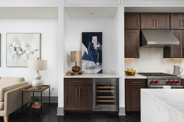 kitchen with wine cooler, tasteful backsplash, wall chimney exhaust hood, dark brown cabinetry, and stainless steel range