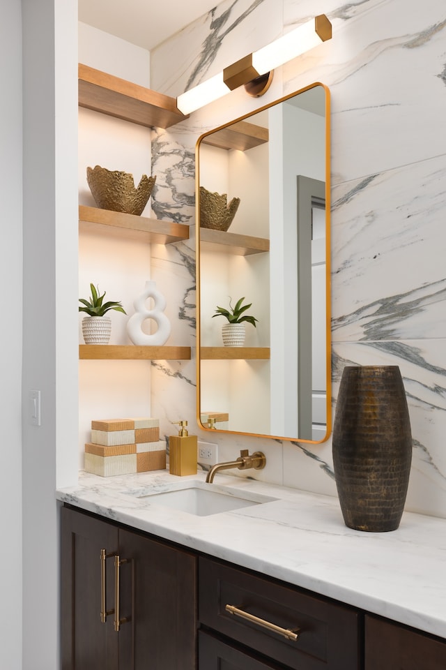 bathroom featuring vanity and decorative backsplash