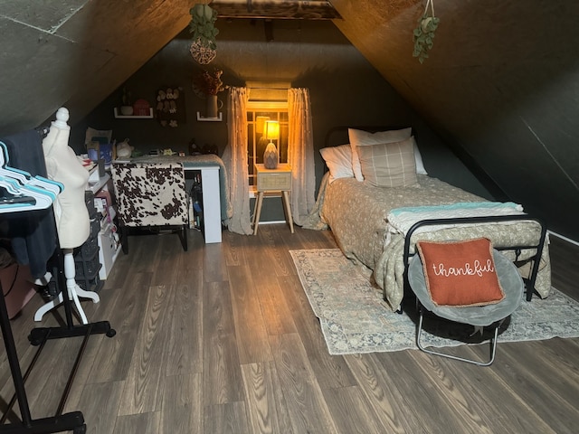 bedroom with vaulted ceiling and dark hardwood / wood-style flooring