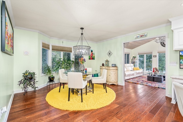 dining space featuring a notable chandelier, ornamental molding, and dark hardwood / wood-style flooring