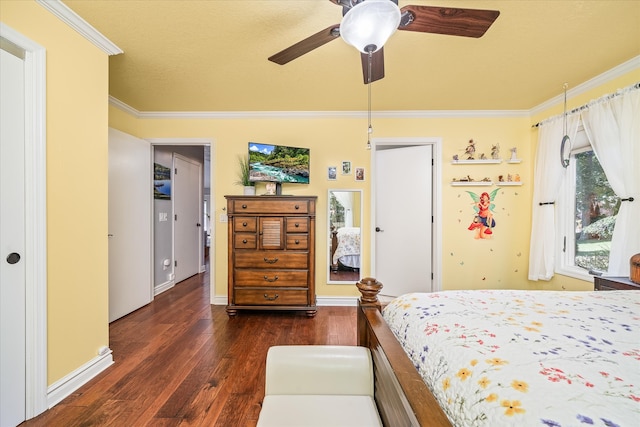 bedroom with ornamental molding, ceiling fan, and dark wood-type flooring