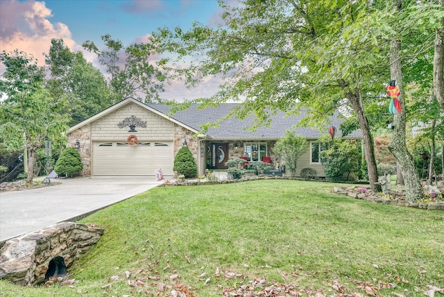 single story home featuring a yard and a garage