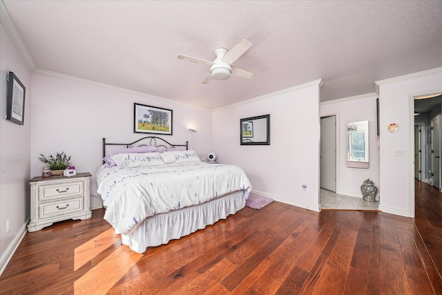 bedroom with a textured ceiling, crown molding, ceiling fan, and hardwood / wood-style flooring