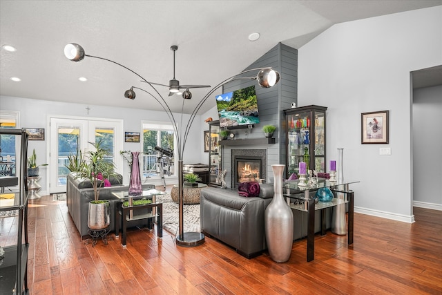 living room with lofted ceiling, ceiling fan, and hardwood / wood-style flooring