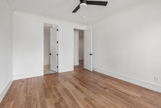 unfurnished room with ceiling fan, light wood-type flooring, and ornamental molding