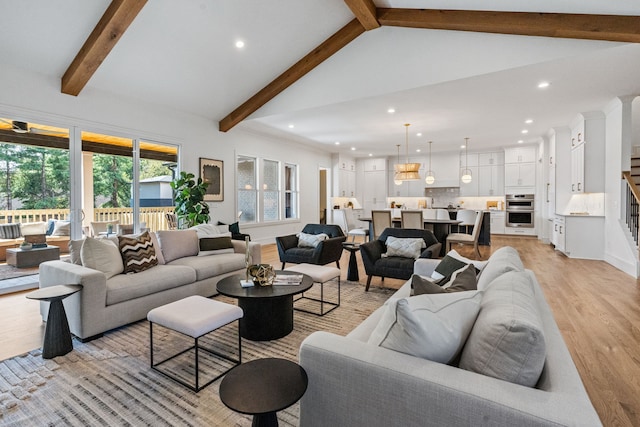 living room featuring light wood-type flooring, beam ceiling, and high vaulted ceiling