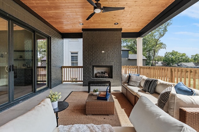 view of patio / terrace featuring an outdoor living space with a fireplace and ceiling fan