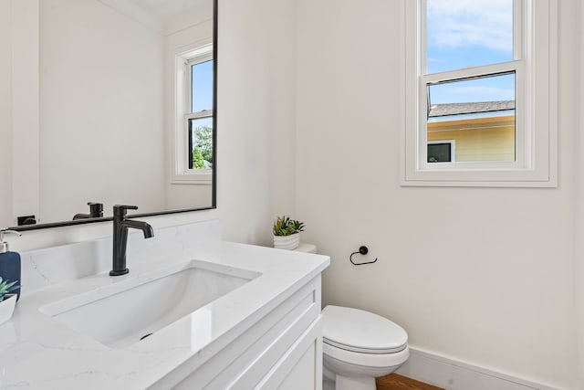 bathroom featuring vanity and toilet