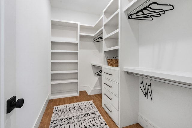 walk in closet featuring light hardwood / wood-style flooring