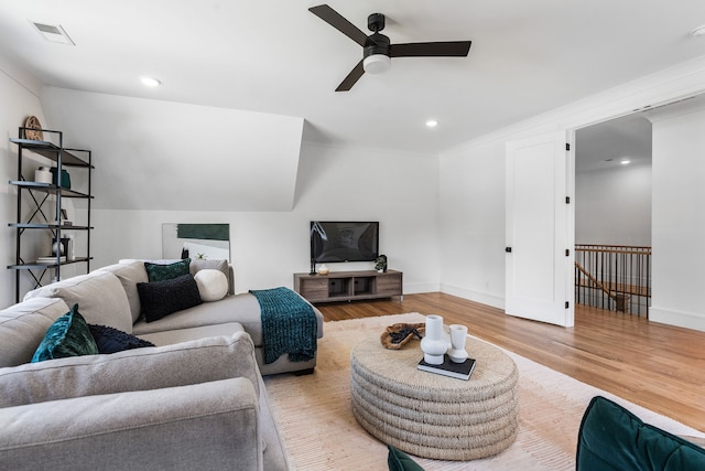 living room with light wood-type flooring and ceiling fan