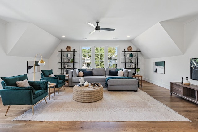 living room with lofted ceiling, ceiling fan, and hardwood / wood-style flooring