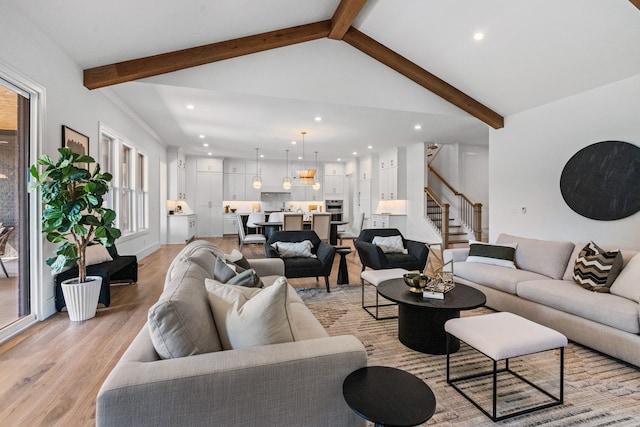 living room with light hardwood / wood-style flooring and lofted ceiling with beams