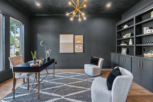 home office with hardwood / wood-style floors and a notable chandelier